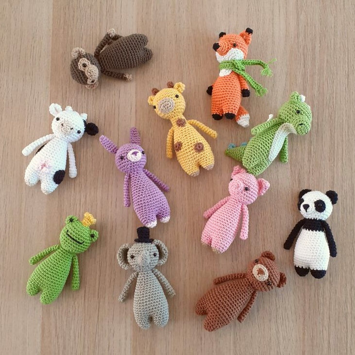 Eleven crocheted animals from the MINI Series PDF Crochet Amigurumi Patterns BUNDLE - randomly lying on the ground
